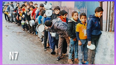 Palestinians scramble for food at a distribution point.