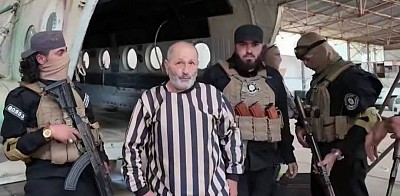 The arrest of Brigadier General Pilot Rajeh Khader Wannous, commander of the 767th Helicopter Squadron in the ousted regime's army, at Mezzeh Military Airport.